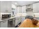 Charming kitchen with farmhouse sink, stainless steel appliances, and modern white cabinetry at 962 Cardova Ne Dr, Atlanta, GA 30324