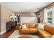 Inviting living room featuring a leather sofa, wood floors, and neutral decor at 962 Cardova Ne Dr, Atlanta, GA 30324