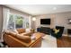 Bright and airy living room featuring a comfortable leather sofa and large window at 962 Cardova Ne Dr, Atlanta, GA 30324