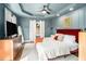 Serene main bedroom featuring plush bedding, and modern decor with a ceiling fan and recessed lighting at 962 Cardova Ne Dr, Atlanta, GA 30324