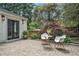 Beautiful patio area featuring neutral chairs, a table, and manicured landscaping at 962 Cardova Ne Dr, Atlanta, GA 30324