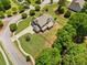 An aerial view showcases a beautiful home on a sprawling lot with mature trees in a desirable neighborhood at 161 Archstone Sq, Mcdonough, GA 30253