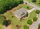 Aerial view of a house with a large manicured lawn and fenced backyard in a serene neighborhood setting at 161 Archstone Sq, Mcdonough, GA 30253