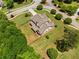 A beautiful home on a large, manicured lot featuring a fenced backyard and mature trees, aerial view at 161 Archstone Sq, Mcdonough, GA 30253