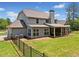 Spacious backyard featuring a covered patio, fenced yard, and well-maintained lawn at 161 Archstone Sq, Mcdonough, GA 30253