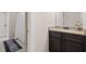 Detailed bathroom featuring a granite vanity with dark wood cabinets, a view into shower space at 161 Archstone Sq, Mcdonough, GA 30253