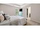 Cozy bedroom with neutral walls, carpet, a blue dresser, and a comfortable queen-sized bed at 161 Archstone Sq, Mcdonough, GA 30253