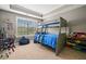 Comfortable bedroom featuring a bunk bed, study area, and a bright window at 161 Archstone Sq, Mcdonough, GA 30253