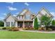 Charming two-story home with stone accents, manicured lawn, and a welcoming front porch at 161 Archstone Sq, Mcdonough, GA 30253