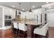 Spacious kitchen with an island, bar stool seating, stainless steel appliances, and hardwood flooring at 161 Archstone Sq, Mcdonough, GA 30253