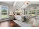 Airy main bedroom with vaulted ceiling, ceiling fan, hardwood floors, and a bright sitting area at 161 Archstone Sq, Mcdonough, GA 30253