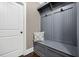 Cozy mudroom with a gray bench, hooks, gray shelving, and a white paneled door at 161 Archstone Sq, Mcdonough, GA 30253