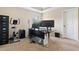 Functional office space featuring multiple monitors, an exercise bike, and neutral carpet at 161 Archstone Sq, Mcdonough, GA 30253