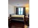 Small bedroom with hardwood floors, natural light and dark window coverings at 260 Manning Sw Rd # 42, Marietta, GA 30064