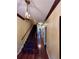 Inviting hallway with hardwood floors, staircase, and vintage pendant lighting fixture at 260 Manning Sw Rd # 42, Marietta, GA 30064