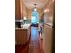 Galley kitchen featuring modern appliances, light wood cabinets, and a view of living space at 260 Manning Sw Rd # 42, Marietta, GA 30064