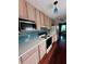Galley kitchen with updated appliances, light wood cabinets, and hardwood flooring at 260 Manning Sw Rd # 42, Marietta, GA 30064