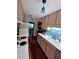 Galley kitchen featuring blue backsplash, appliances, hardwood floors, and view of dining room at 260 Manning Sw Rd # 42, Marietta, GA 30064
