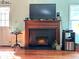 Cozy living room with a fireplace featuring a wooden mantle and modern insert at 260 Manning Sw Rd # 42, Marietta, GA 30064