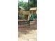 Outdoor wooden playground with a slide, climbing structures, and a comfortable bench for relaxation at 260 Manning Sw Rd # 42, Marietta, GA 30064