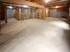 Spacious unfinished basement ready to be customized, with exposed beams and concrete floor at 4345 Park Brooke Trce, Alpharetta, GA 30022
