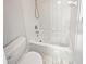 A clean and bright white bathroom with a shower and tub combination and marble floor at 4345 Park Brooke Trce, Alpharetta, GA 30022