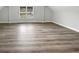 Bright bedroom with a window providing natural light and durable, modern, light brown floors at 4345 Park Brooke Trce, Alpharetta, GA 30022