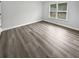 Bright bedroom with a window providing natural light and durable, modern, light brown floors at 4345 Park Brooke Trce, Alpharetta, GA 30022