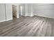 A spacious bedroom featuring neutral walls, a walk in closet, and durable, modern, light brown floors at 4345 Park Brooke Trce, Alpharetta, GA 30022