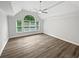 A spacious bedroom featuring a cathedral ceiling, ceiling fan, and a large window with lots of natural light at 4345 Park Brooke Trce, Alpharetta, GA 30022