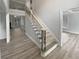 Welcoming entryway showcasing an elegant staircase with modern railing and light hardwood floors at 4345 Park Brooke Trce, Alpharetta, GA 30022