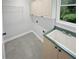 Functional laundry room with ample storage cabinets, sink, and bright window at 4345 Park Brooke Trce, Alpharetta, GA 30022