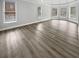 Bright living room featuring hardwood floors, tray ceilings, and large windows at 4345 Park Brooke Trce, Alpharetta, GA 30022