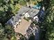 Bird's eye view showcases manicured lawns, a pool, a driveway and an elegant home framed by mature trees at 4375 Mount Paran Pkwy Nw, Atlanta, GA 30327