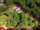 Expansive aerial view of a home surrounded by lush forest, highlighting its secluded location and private pool at 4375 Mount Paran Pkwy Nw, Atlanta, GA 30327