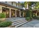 Beautiful brick home featuring a large stone patio, elegant landscaping, and access to an outdoor kitchen and covered veranda at 4375 Mount Paran Pkwy Nw, Atlanta, GA 30327