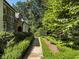 A stone path leading through a landscaped backyard with mature trees at 4375 Mount Paran Pkwy Nw, Atlanta, GA 30327