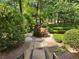 A stone path leading through a backyard garden with mature trees at 4375 Mount Paran Pkwy Nw, Atlanta, GA 30327