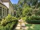 Landscaped backyard with manicured hedges, a stone pathway, and lush greenery at 4375 Mount Paran Pkwy Nw, Atlanta, GA 30327