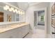 Elegant bathroom featuring a granite countertop, soft light fixtures, and neutral-toned tile at 4375 Mount Paran Pkwy Nw, Atlanta, GA 30327