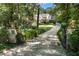 Long stone driveway leading to a beautiful home surrounded by mature trees and lush landscaping at 4375 Mount Paran Pkwy Nw, Atlanta, GA 30327
