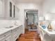 Inviting hallway with hardwood floors, white cabinets, marble countertops, and views into the living room at 4375 Mount Paran Pkwy Nw, Atlanta, GA 30327