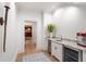 Hallway includes wet bar with sink, under counter beverage cooler, and unique wall decor at 4375 Mount Paran Pkwy Nw, Atlanta, GA 30327