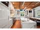 Spacious kitchen features white cabinets, a marble island, stainless steel appliances, and wooden ceiling beams at 4375 Mount Paran Pkwy Nw, Atlanta, GA 30327