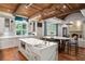 Open kitchen and living area with wood-beamed ceiling and marble island at 4375 Mount Paran Pkwy Nw, Atlanta, GA 30327