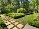 Beautifully landscaped garden featuring manicured hedges, a stone-paved pathway, and lush greenery at 4375 Mount Paran Pkwy Nw, Atlanta, GA 30327