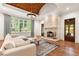Cozy living room featuring stone fireplace, hardwood floors, and backyard views at 4375 Mount Paran Pkwy Nw, Atlanta, GA 30327