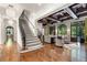 Open-concept living room with wooden floors, coffered ceiling, staircase, and great view at 4375 Mount Paran Pkwy Nw, Atlanta, GA 30327