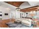 Spacious living room with brick ceiling and stone fireplace flows into an eat-in kitchen at 4375 Mount Paran Pkwy Nw, Atlanta, GA 30327