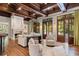 Cozy living room with fireplace, beamed ceiling, and french doors to the outdoor area at 4375 Mount Paran Pkwy Nw, Atlanta, GA 30327